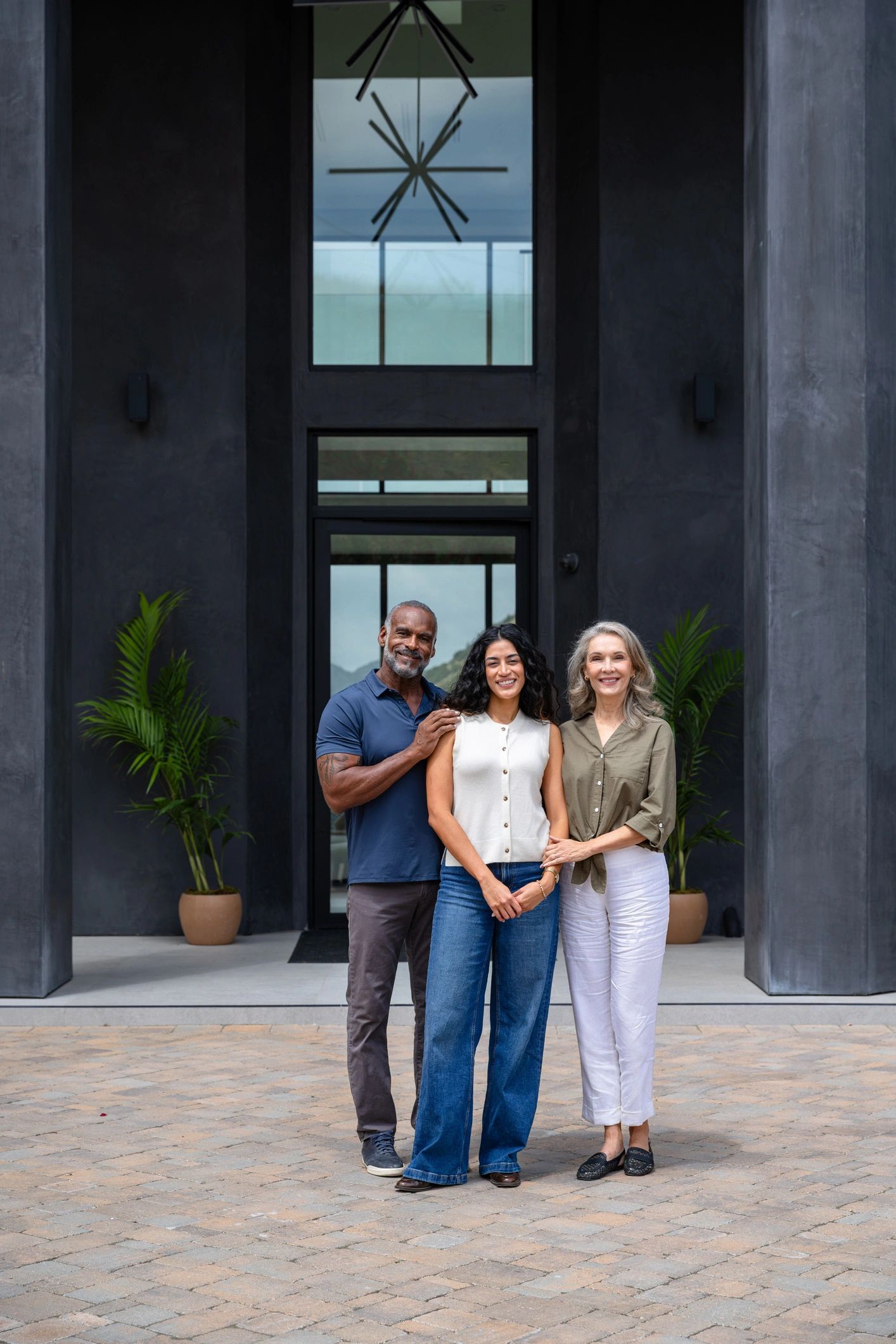 Professional advisors in front of a luxury home